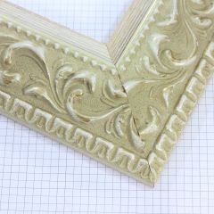 A large, reverse curve profile frame with an intricate leaf design bordered by a geometric outer edge and beaded inner lip.  A White matte base with patina for added depth on the topmost points of the design. Strong, solid wood construction.

3.25 " witdth: ideal for large and oversize (extra large) images.